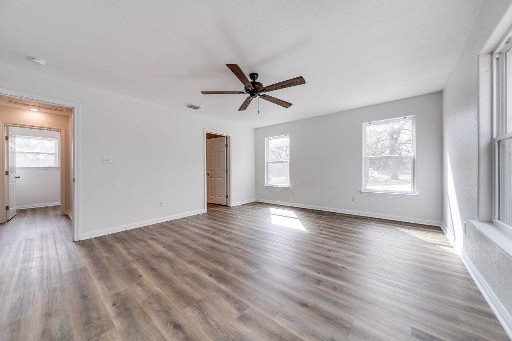 955 Axis Circle Fredericksburg, TX 78624 - Photo 12 of 41 Bright and open primary bedroom with ceiling fan f