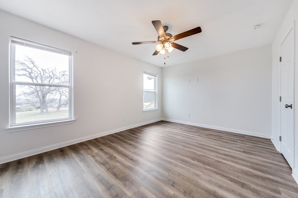 955 Axis Circle Fredericksburg, TX 78624 - Photo 19 of 41 Bedroom 3 has views of the trees and hill country.