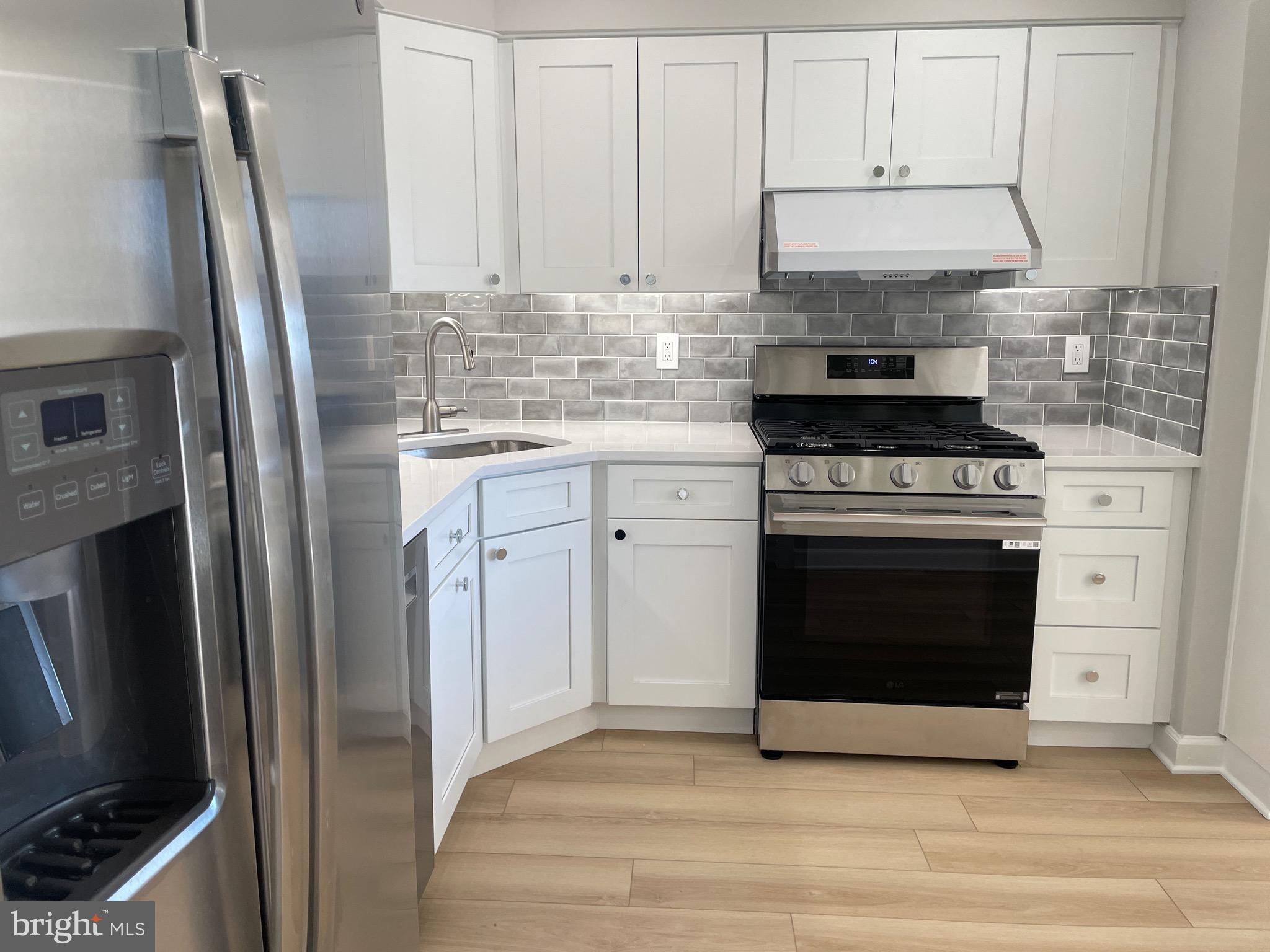 5225 Pooks Hill Road, Unit 828S Bethesda, MD 20814 - Photo 1 of 63 a kitchen with stainless steel appliances wooden floor sink and stove