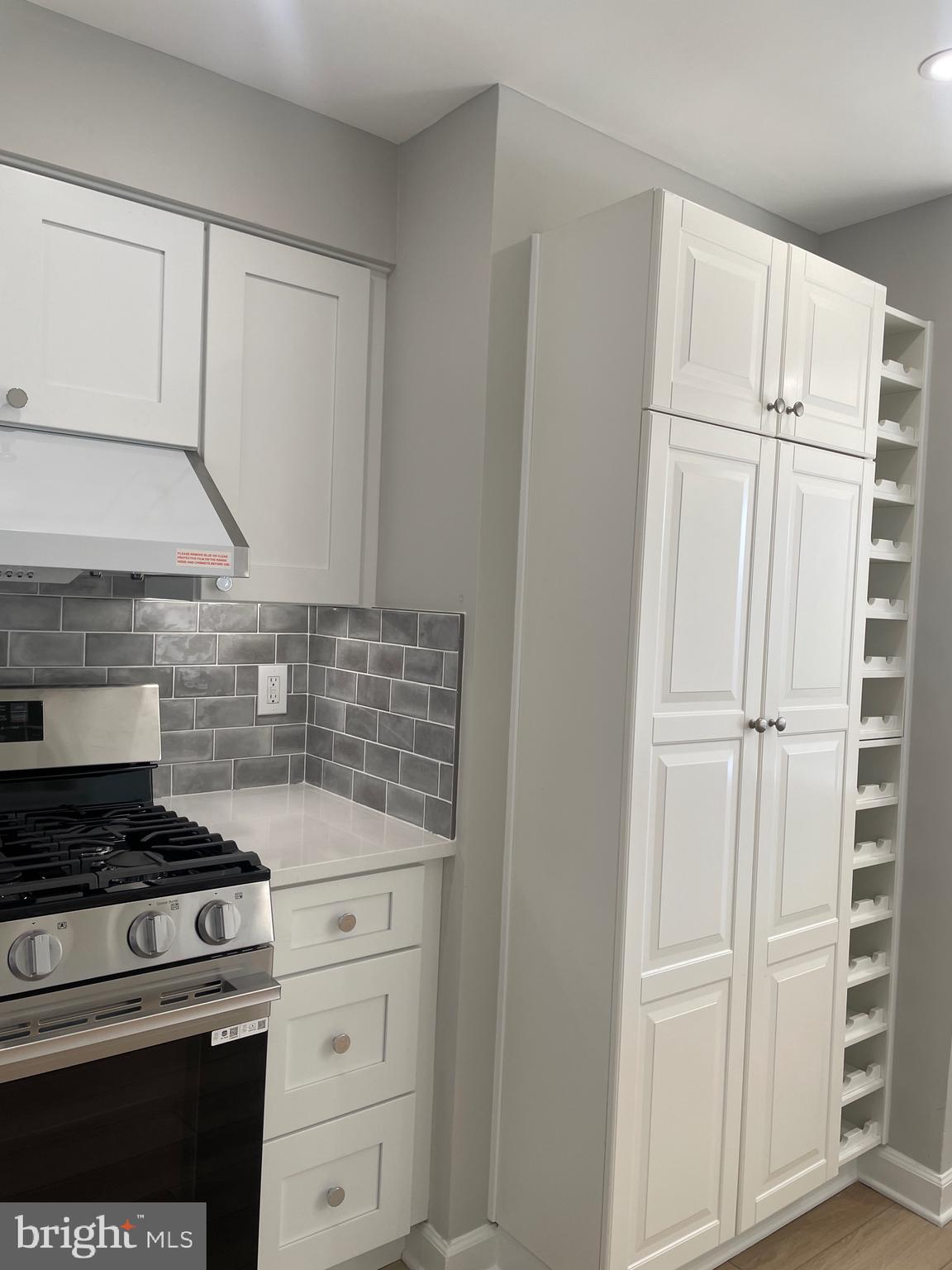 5225 Pooks Hill Road, Unit 828S Bethesda, MD 20814 - Photo 13 of 72 a kitchen with white cabinets and white appliances