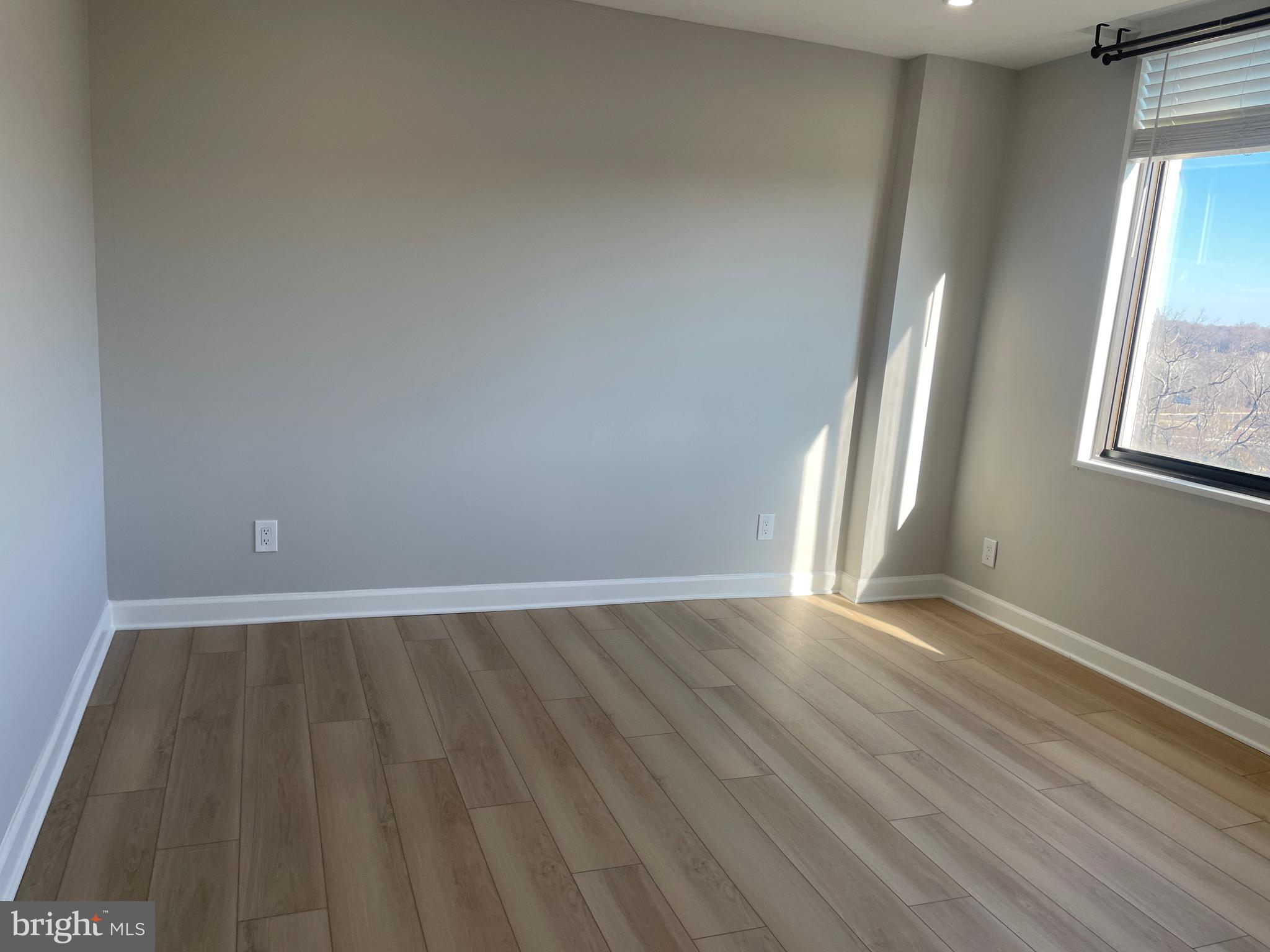 5225 Pooks Hill Road, Unit 828S Bethesda, MD 20814 - Photo 13 of 63 an empty room with wooden floor and windows