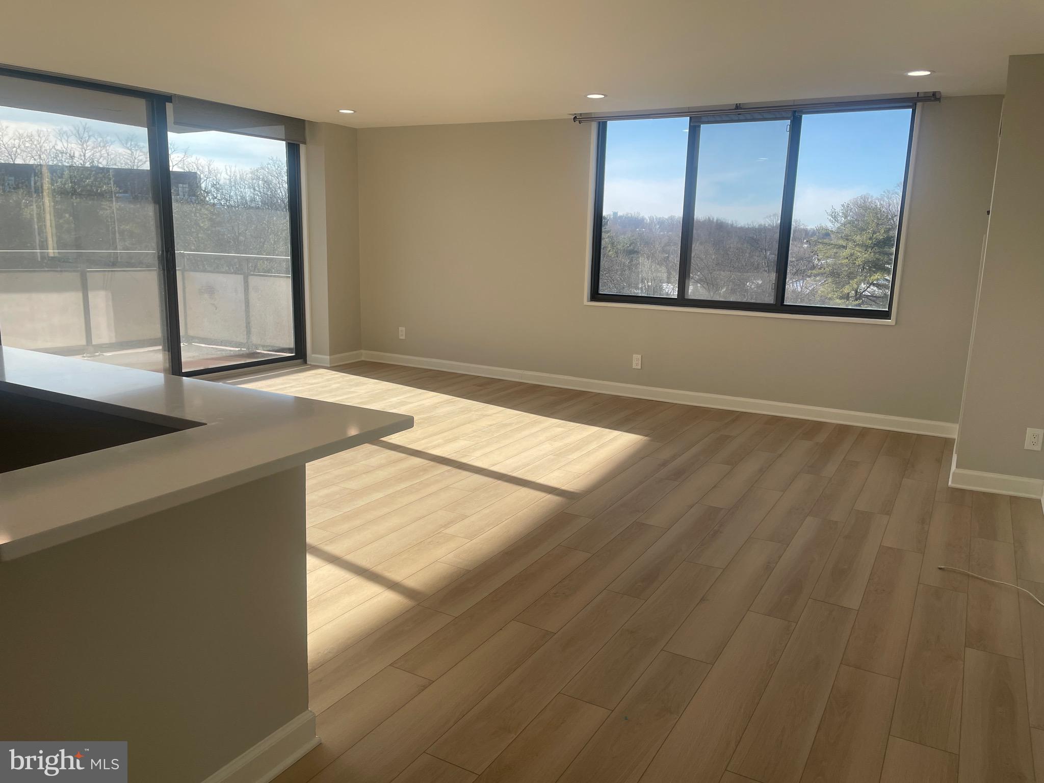 5225 Pooks Hill Road, Unit 828S Bethesda, MD 20814 - Photo 4 of 72 an empty room with wooden floor and windows