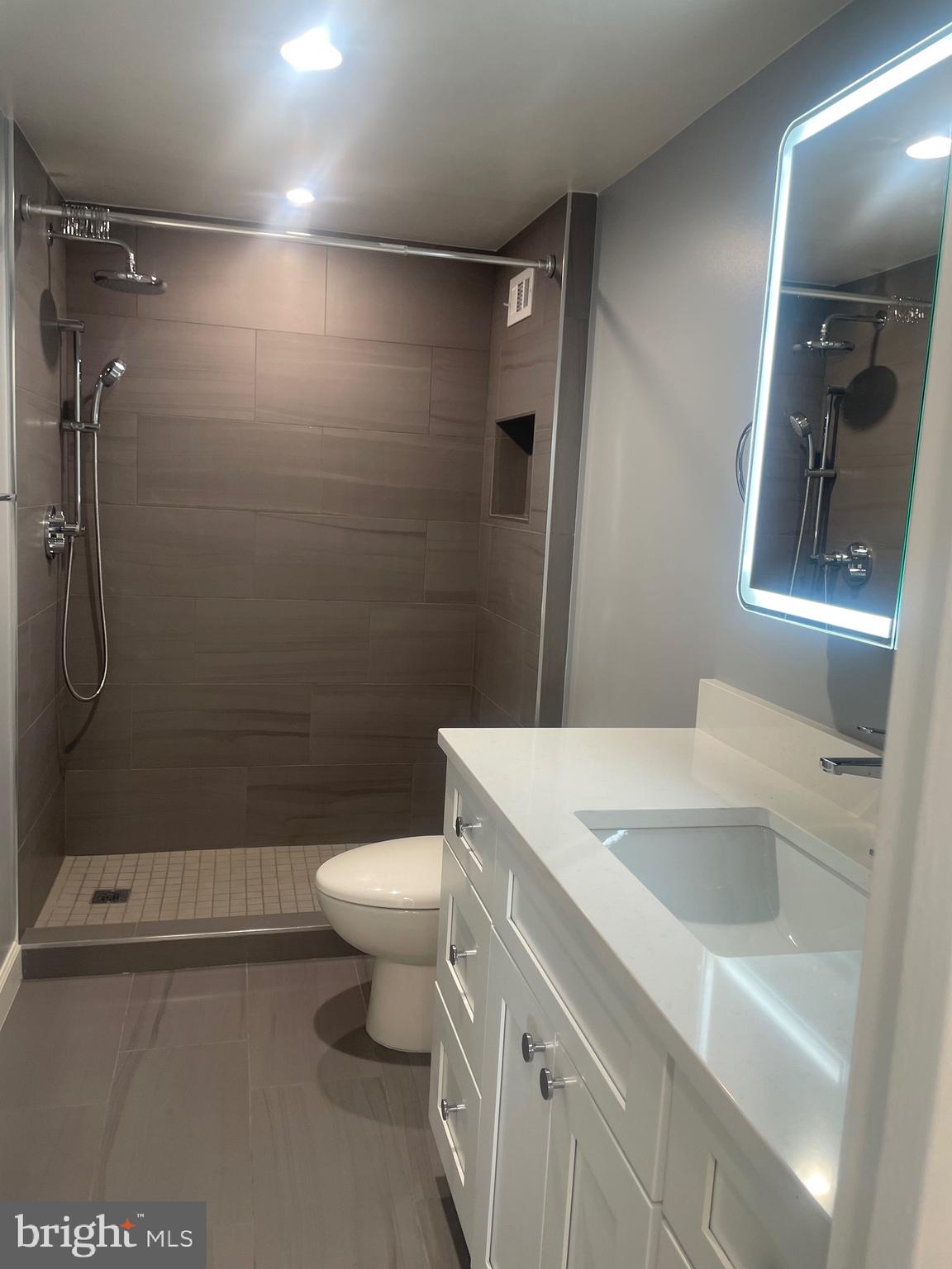 5225 Pooks Hill Road, Unit 828S Bethesda, MD 20814 - Photo 8 of 72 a bathroom with a sink a toilet and shower