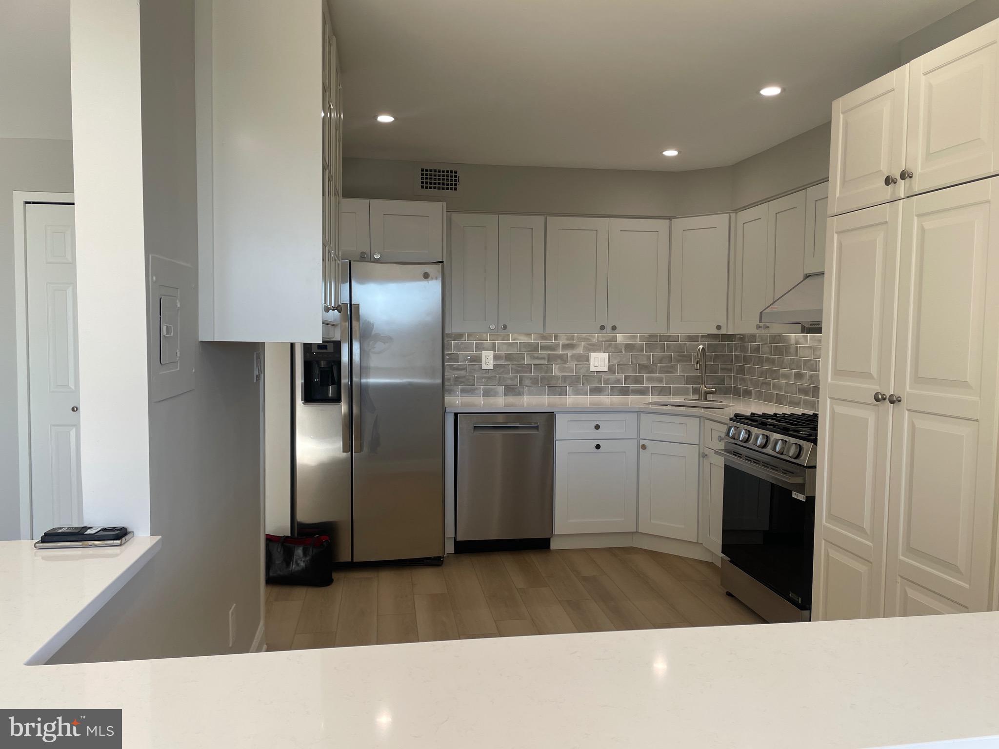 5225 Pooks Hill Road, Unit 828S Bethesda, MD 20814 - Photo 9 of 63 a kitchen with stainless steel appliances granite countertop a refrigerator sink and cabinets