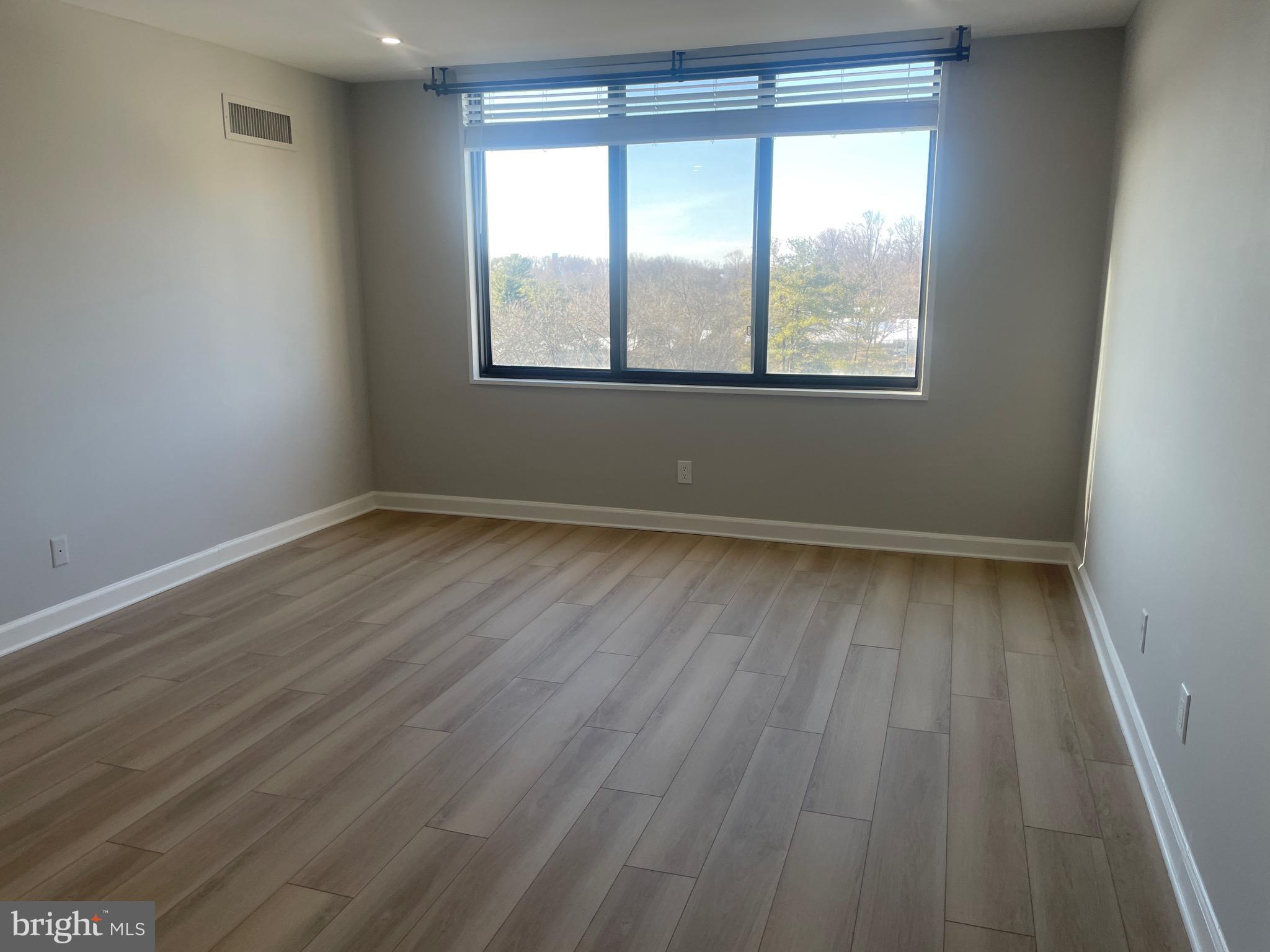 5225 Pooks Hill Road, Unit 828S Bethesda, MD 20814 - Photo 10 of 72 an empty room with wooden floor and windows