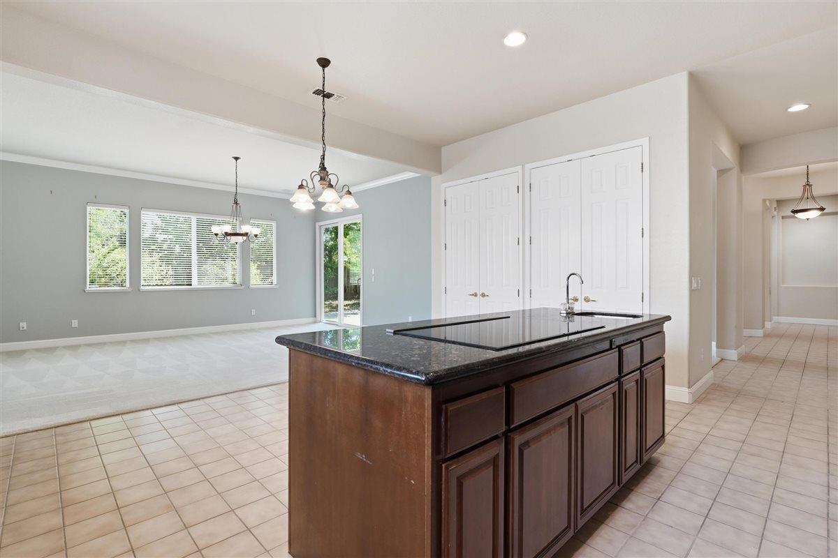 4129 Poppleton Way Carmichael, CA 95608 - Photo 15 of 48 a kitchen with kitchen island granite countertop a sink and a stove