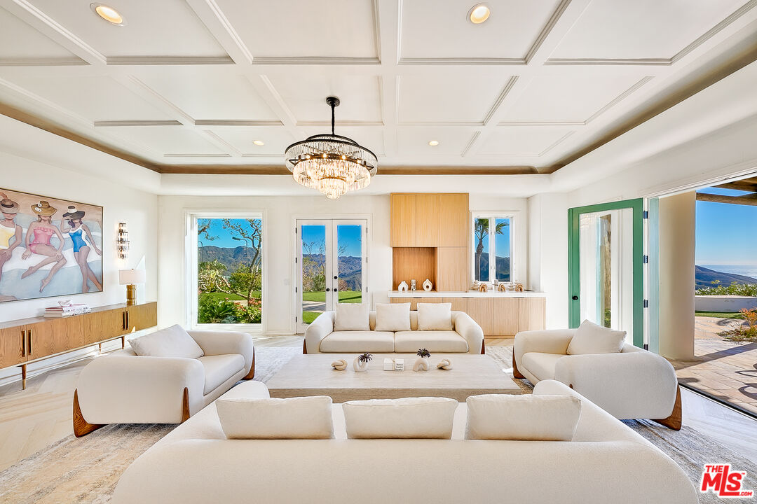 10502 Yellow Hill Road Malibu, CA 90265 - Photo 14 of 22 a living room with furniture a chandelier and a large window