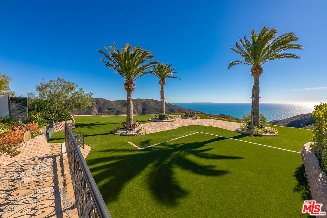 10502 Yellow Hill Road Malibu, CA 90265 - Photo 8 of 22 a view of a swimming pool with a table and chairs