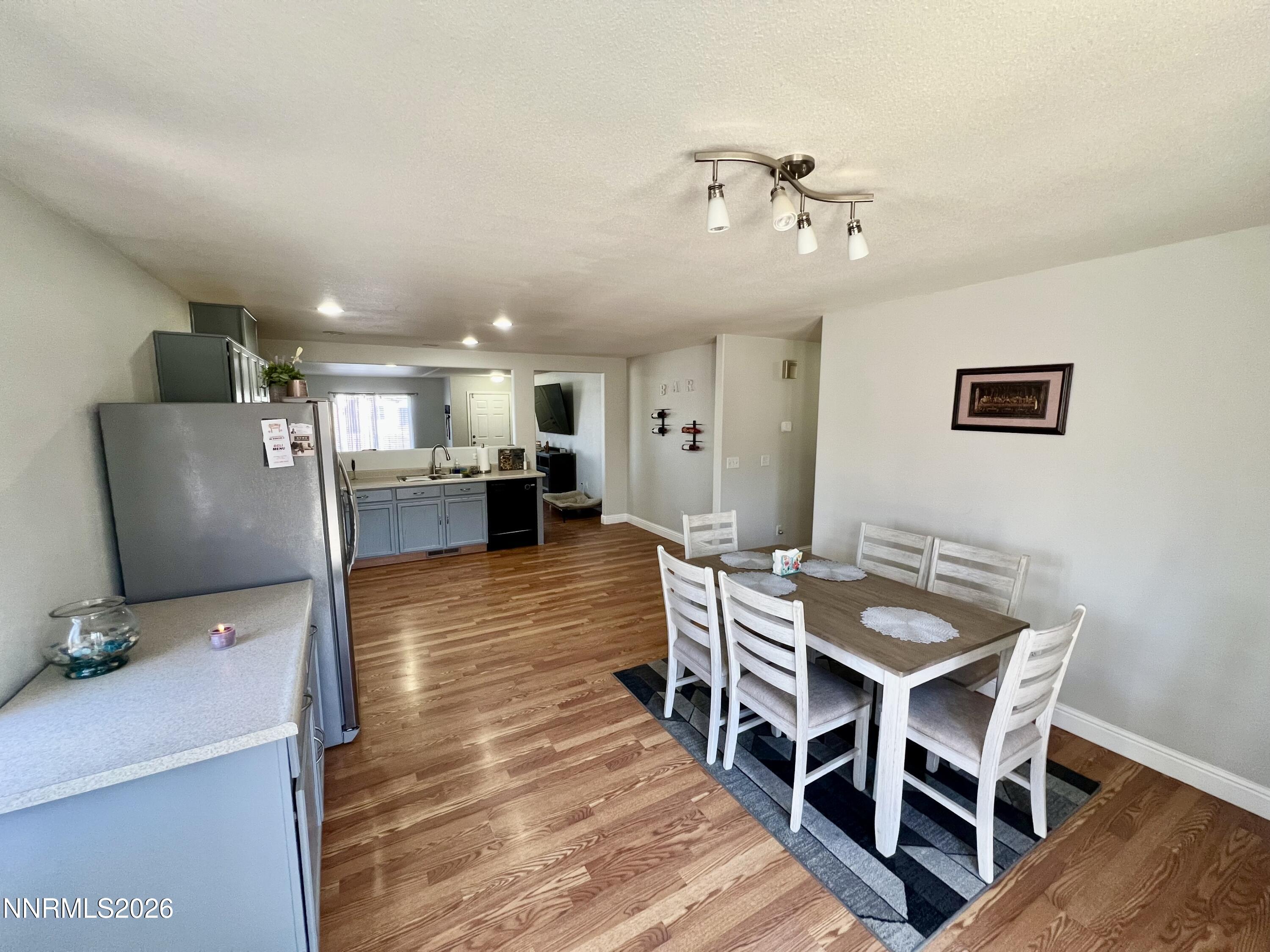 7690 East Key Largo Court Reno, NV 89506 - Photo 12 of 24 a view of a dining room with furniture and wooden floor