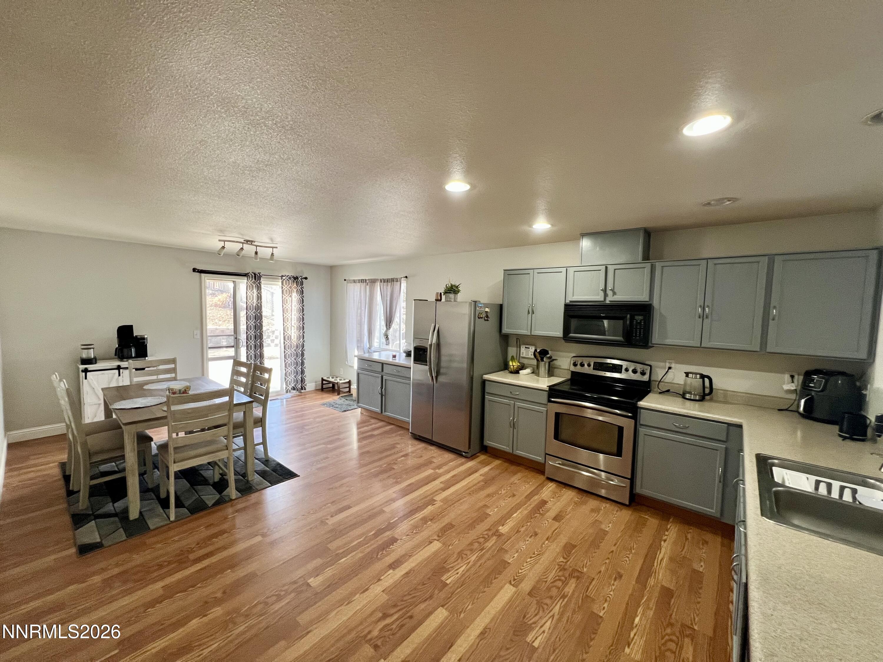 7690 East Key Largo Court Reno, NV 89506 - Photo 13 of 24 a large kitchen with stainless steel appliances and a stove top oven