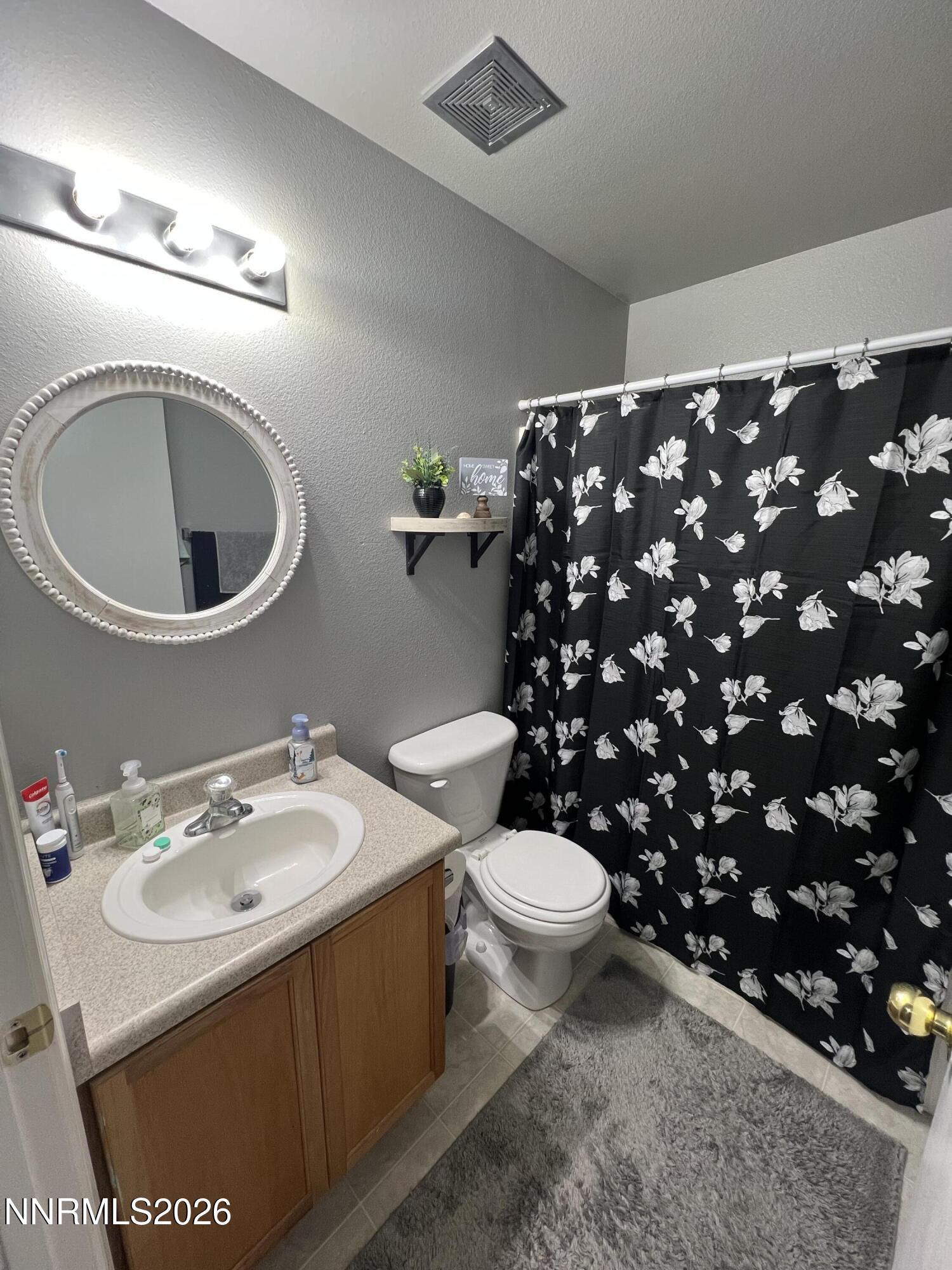 7690 East Key Largo Court Reno, NV 89506 - Photo 16 of 24 a bathroom with a sink toilet and a mirror