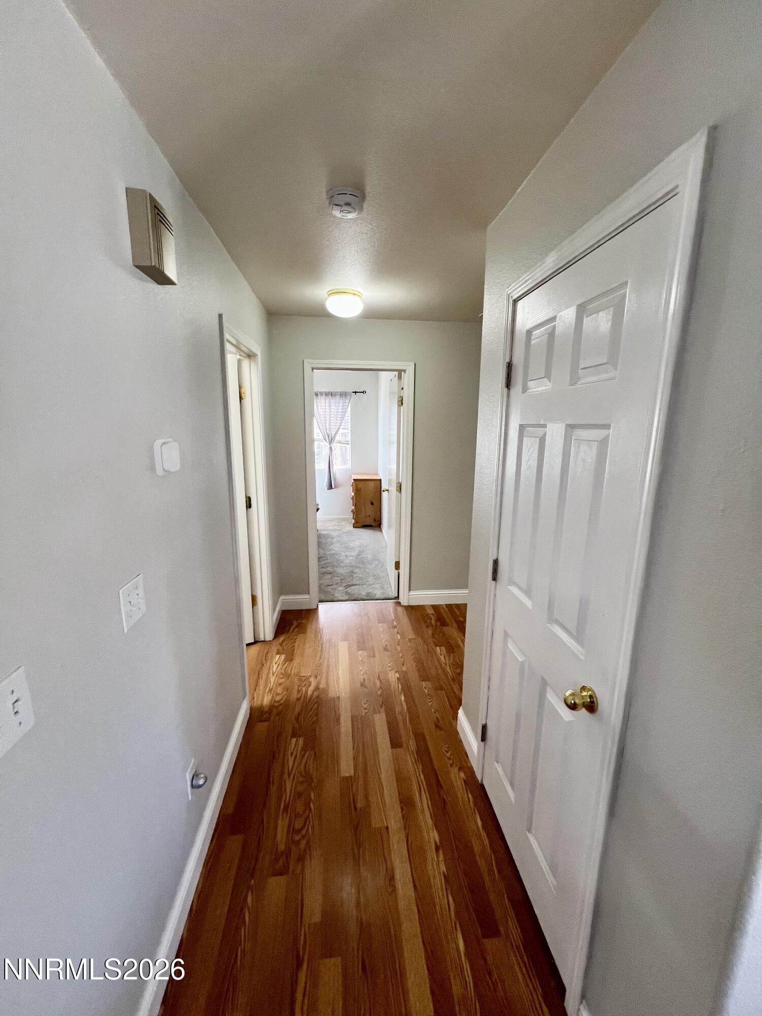 7690 East Key Largo Court Reno, NV 89506 - Photo 17 of 24 a view of a hallway with wooden floor and staircase