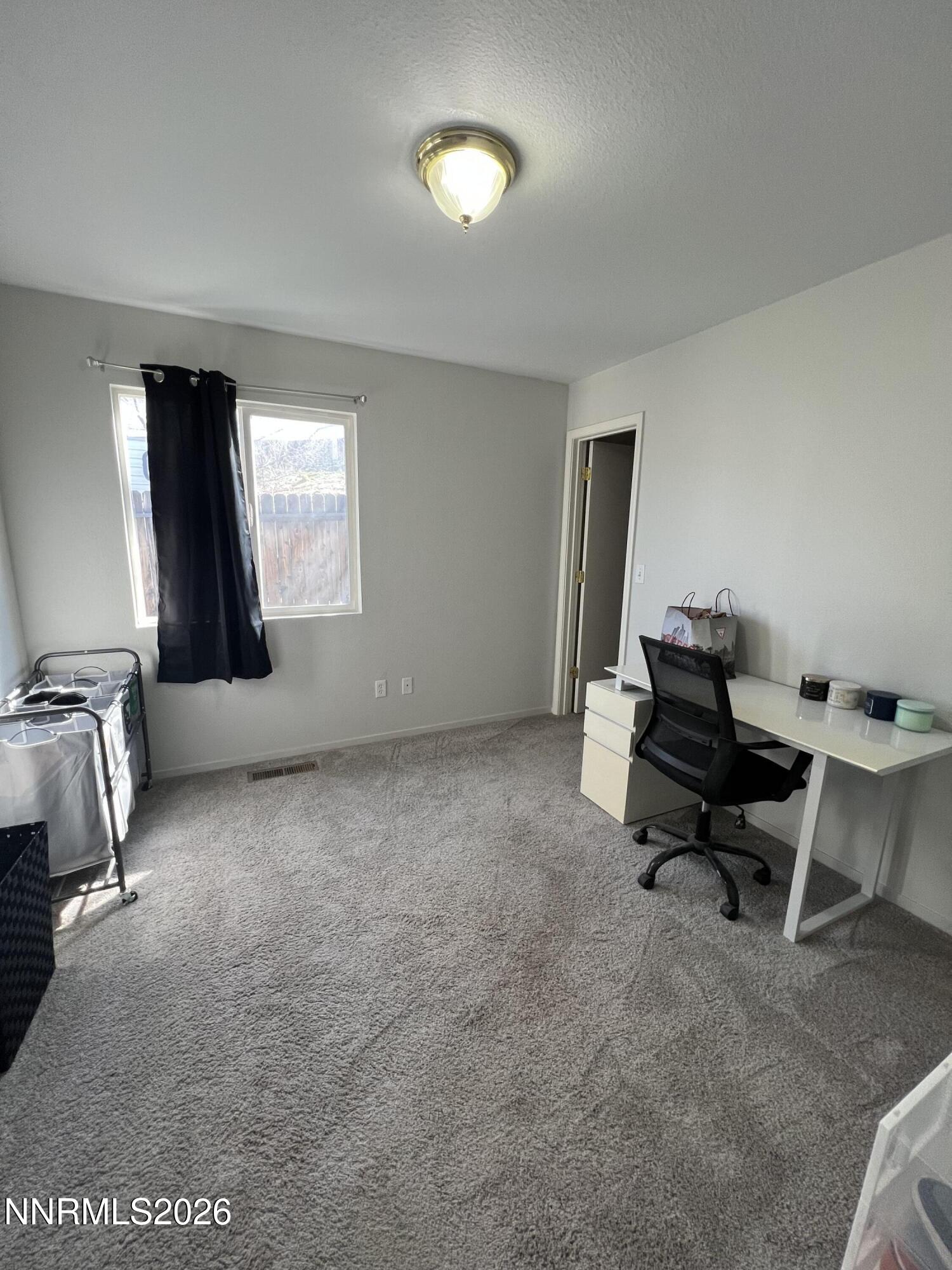 7690 East Key Largo Court Reno, NV 89506 - Photo 19 of 24 a view of a room with gym equipment and a window