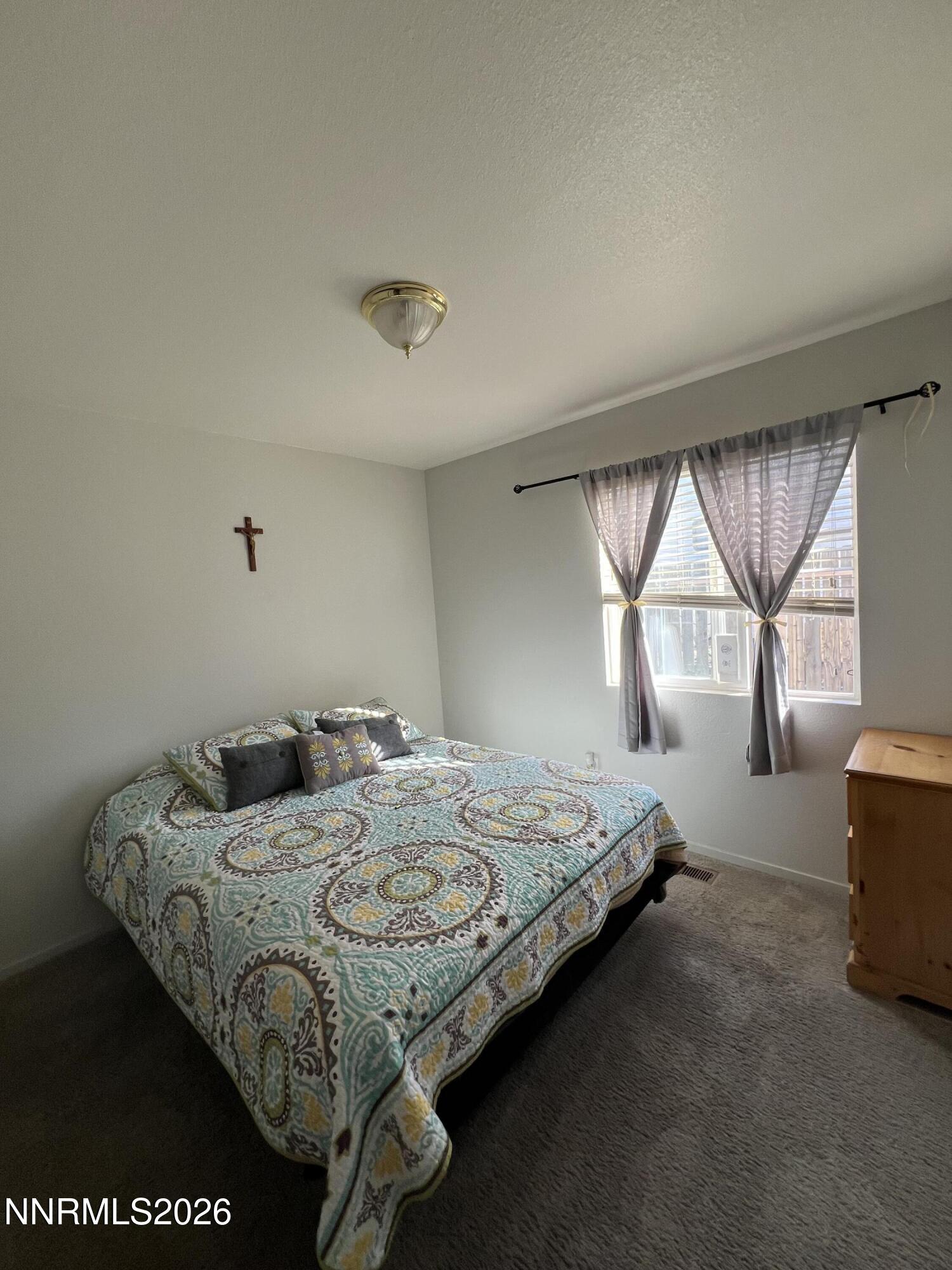 7690 East Key Largo Court Reno, NV 89506 - Photo 20 of 24 a bedroom with a bed and window