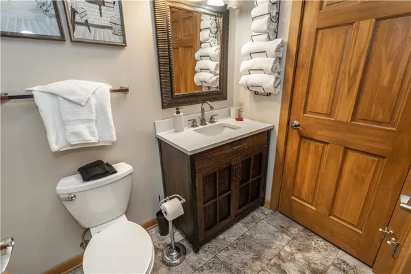 a bathroom with a toilet a sink and a mirror