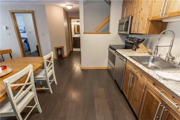 a kitchen with wooden floors and a sink