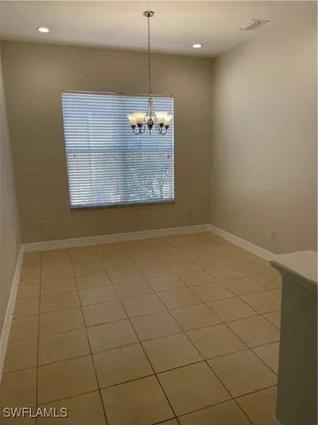 a view of a room with a wooden floor and white walls