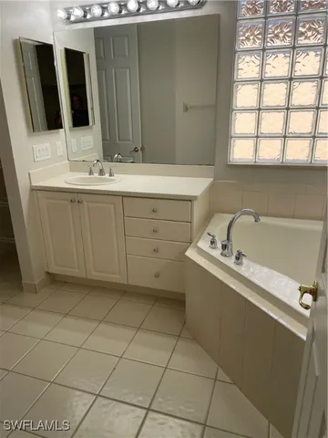 a bathroom with a double vanity sink and mirror