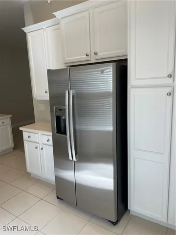 a kitchen with a refrigerator and cabinets