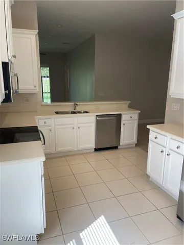 a utility room with cabinets washer and dryer
