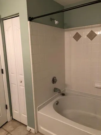 a bathroom with a shower and a bath tub