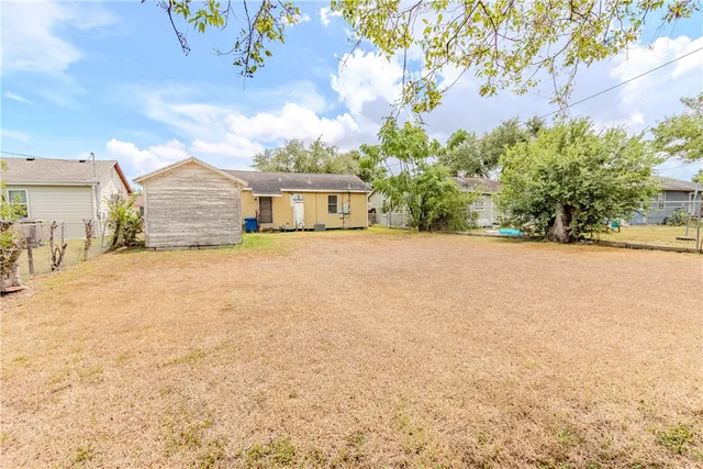 a view of a house with a yard and garage