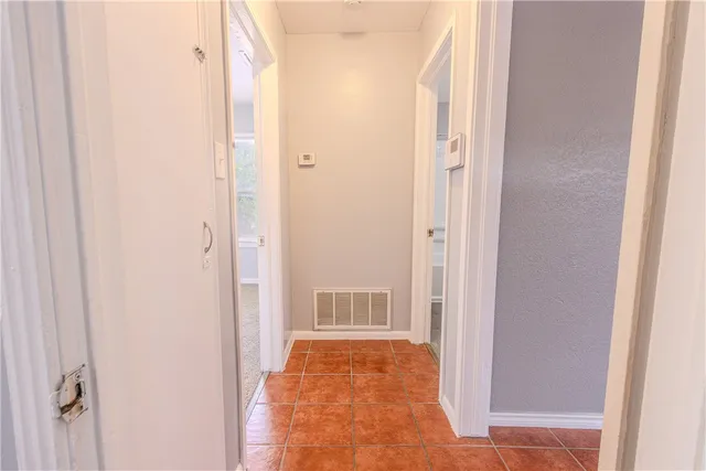 a view of hallway with wooden floor