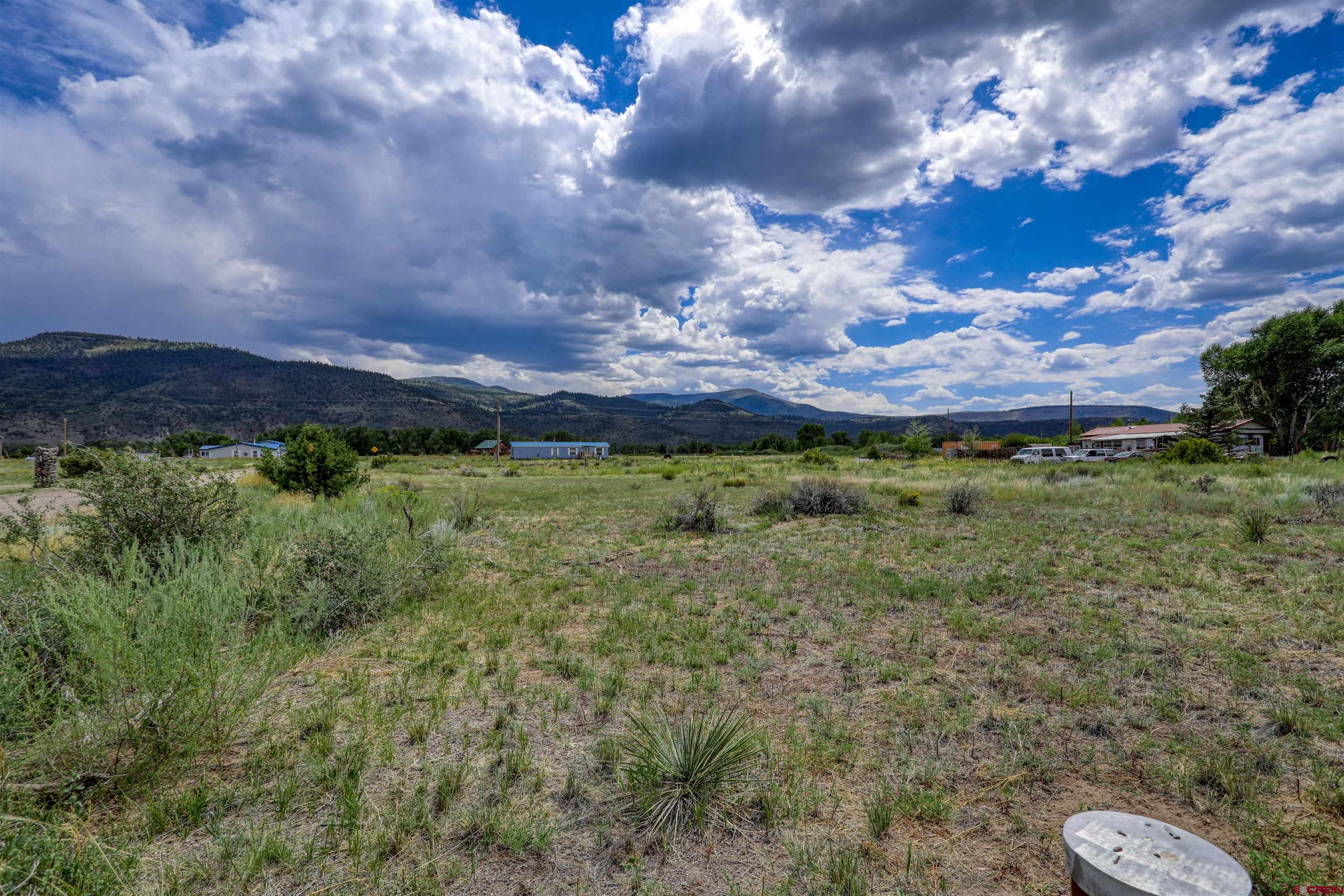 227 Red Feather Road South Fork, CO 81154 - Photo 17 of 32 a view of a lake with a yard