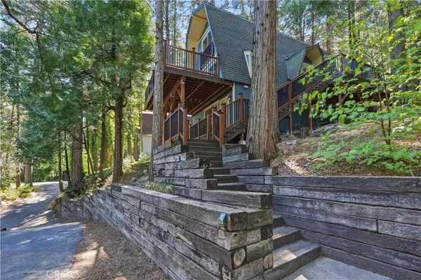 a front view of a house with a tree
