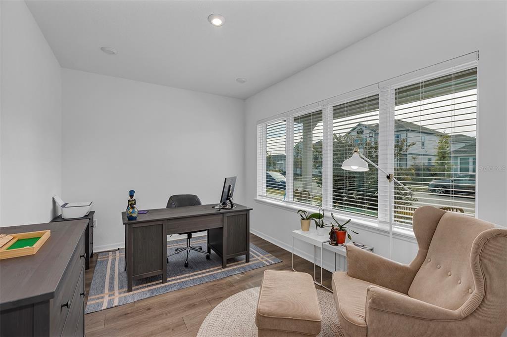 6501 Rover Way St. Cloud, FL 34771 - Photo 13 of 29 a living room with furniture a table and a floor to ceiling window