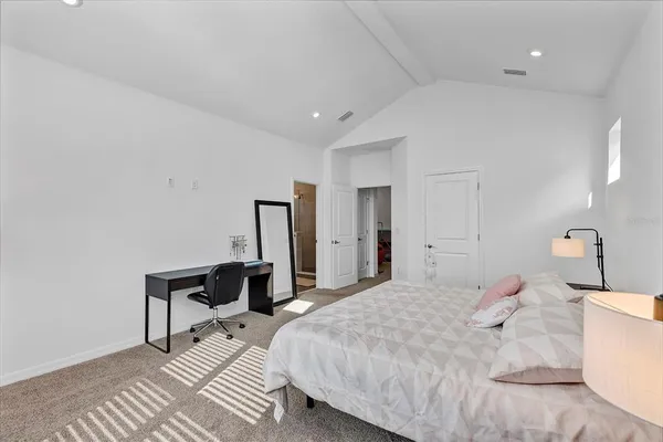 a bedroom with a bed and a lamp on table