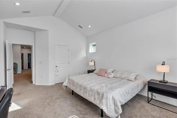 a bedroom with a bed and a lamp