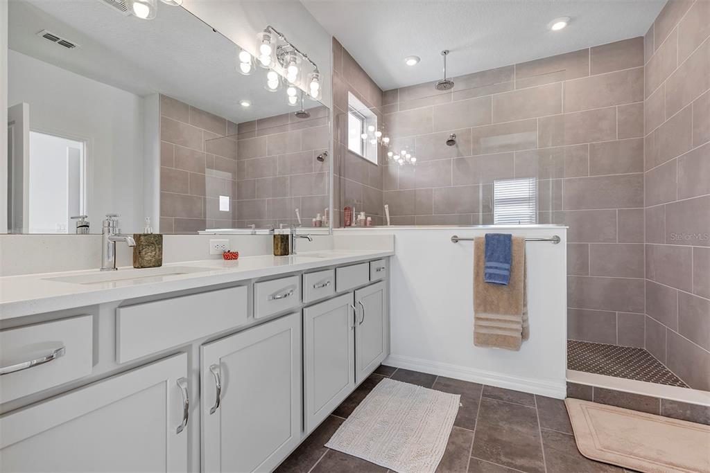 6501 Rover Way St. Cloud, FL 34771 - Photo 20 of 29 a spacious bathroom with double sink and a large mirror