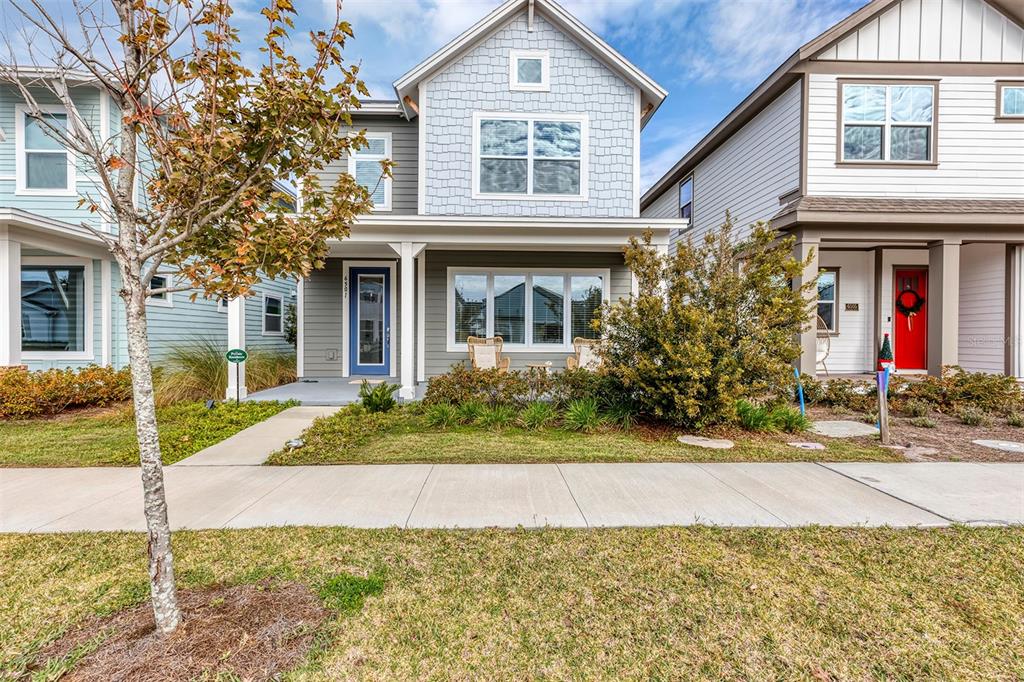 6501 Rover Way St. Cloud, FL 34771 - Photo 2 of 29 a front view of a house with a yard and potted plants