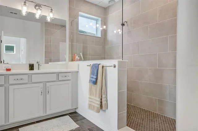a bathroom with a shower sink and mirror