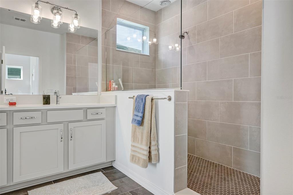 6501 Rover Way St. Cloud, FL 34771 - Photo 21 of 29 a bathroom with a shower sink and mirror