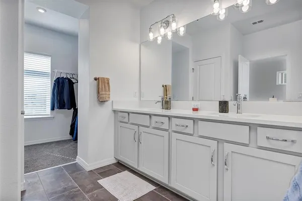 a bathroom with a sink a vanity and a mirror