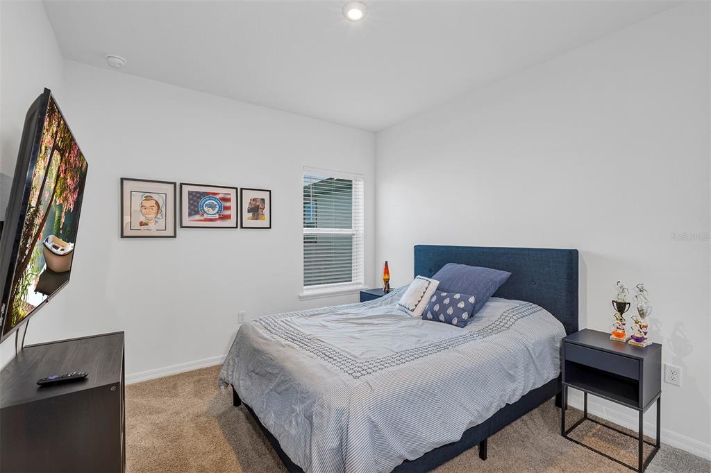 6501 Rover Way St. Cloud, FL 34771 - Photo 23 of 29 a bedroom with a bed and a lamp on dresser