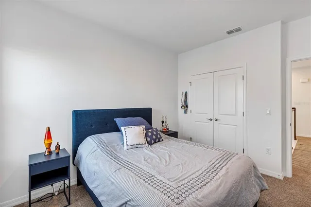 a bedroom with a bed and a chair