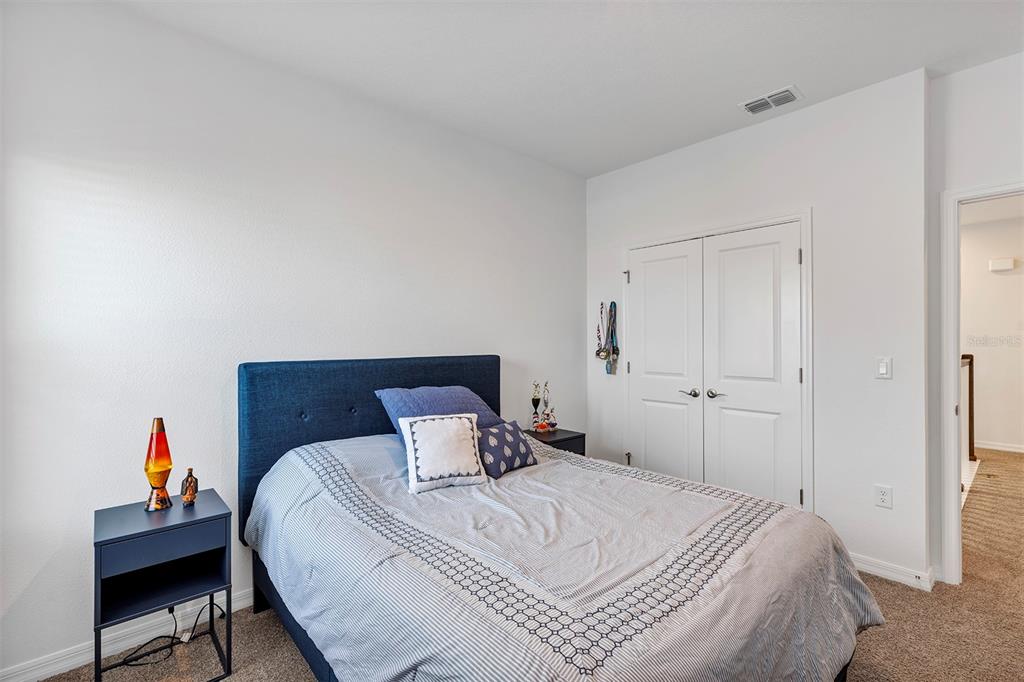 6501 Rover Way St. Cloud, FL 34771 - Photo 24 of 29 a bedroom with a bed and a chair