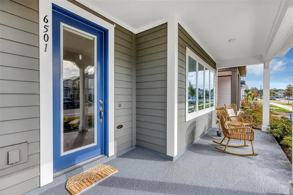 a balcony with table and chairs