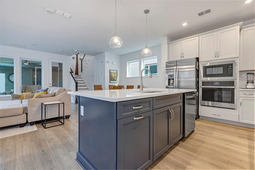 6501 Rover Way St. Cloud, FL 34771 - Photo 5 of 29 a kitchen with kitchen island granite countertop a sink cabinets and stainless steel appliances