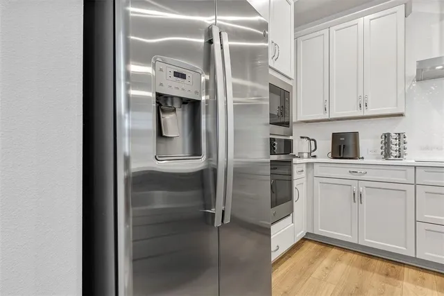 a kitchen with cabinets and stainless steel appliances