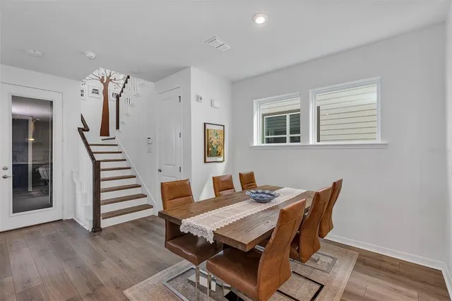 a view of a dining room with furniture and wooden floor