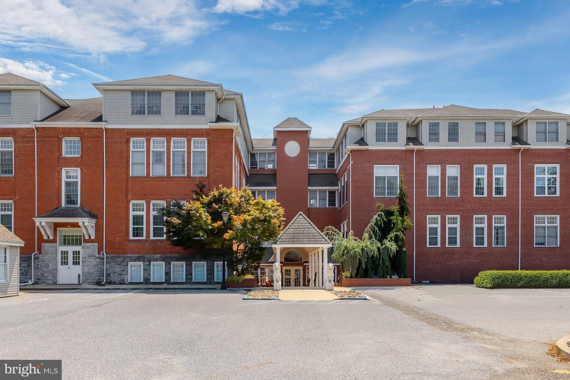 a front view of a residential apartment building with a yard