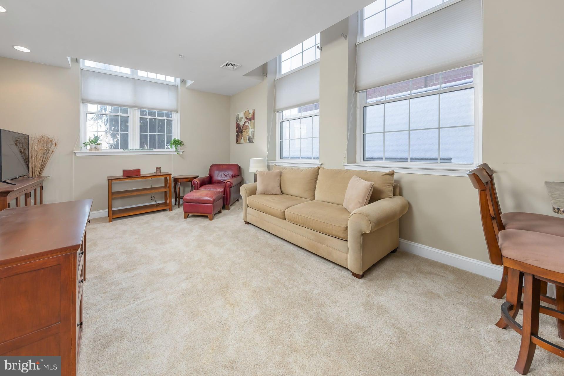 100 Aura Road, Unit 206 Clayton, NJ 08312 - Photo 3 of 25 a living room with furniture and a flat screen tv