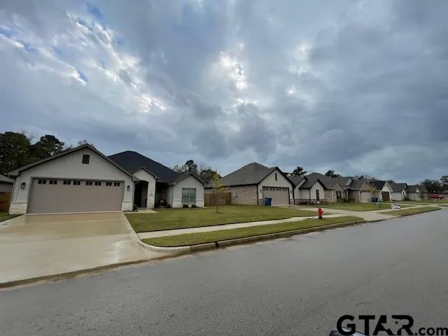 a view of a house with a yard and sitting area