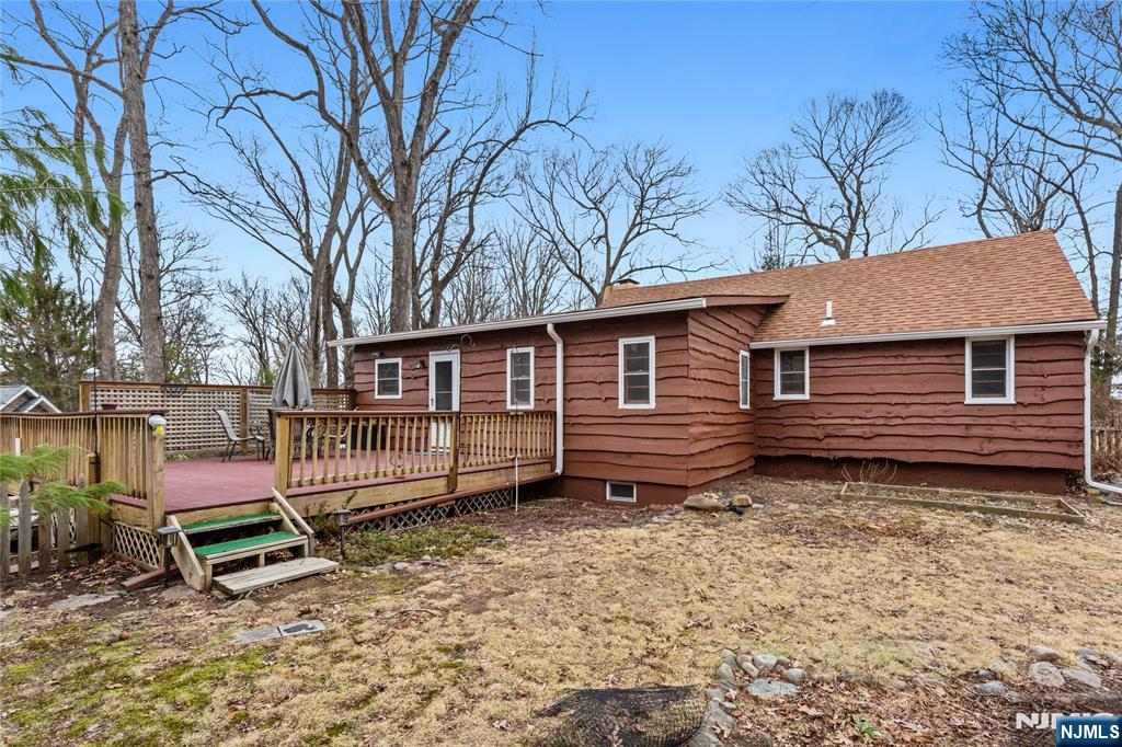 6 Partridge Trail Butler, NJ 07405 - Photo 34 of 37 a backyard of a house with barbeque oven table and chairs