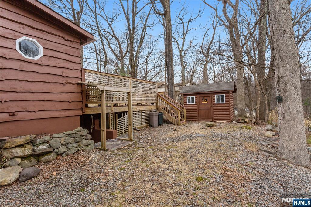 6 Partridge Trail Butler, NJ 07405 - Photo 37 of 37 a backyard of a house with barbeque oven and wooden fence