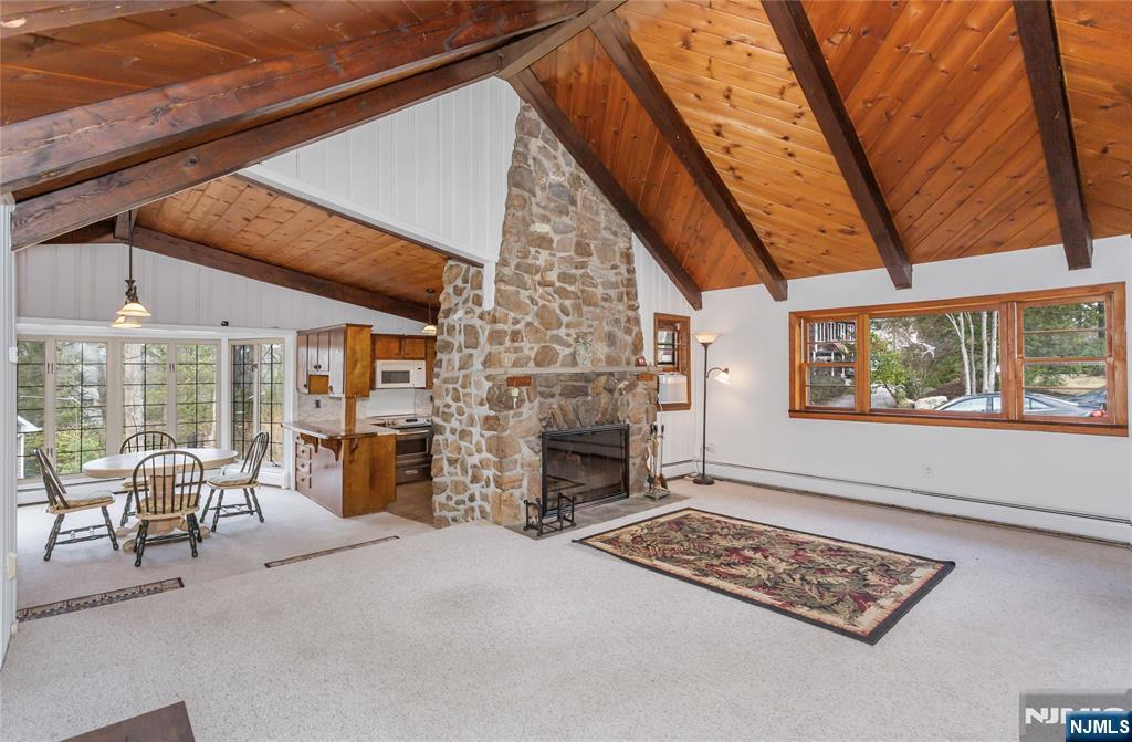 6 Partridge Trail Butler, NJ 07405 - Photo 7 of 37 a living room with furniture a fireplace and a floor to ceiling window